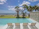 Luxury pool with ocean view and lounge chairs