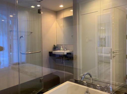 Modern bathroom with glass shower doors and large bathtub