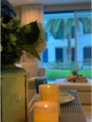 Cozy dining space with candles, flowers, and a view of the garden