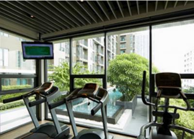 Residential gym with treadmills and view of courtyard