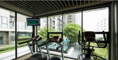 Residential gym with treadmills and view of courtyard