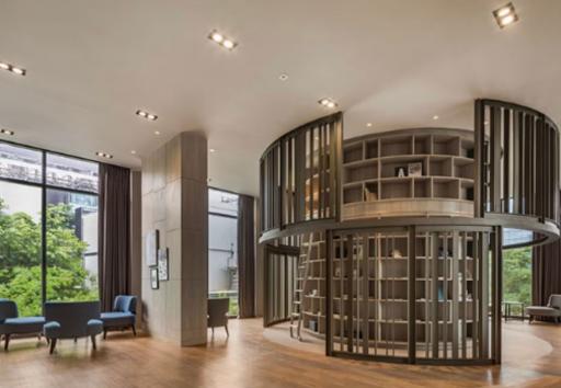 Spacious modern living room with a unique circular bookshelf and large windows