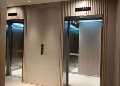 Modern elevator lobby with wooden panels and ambient lighting