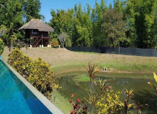 Explore Chiang Mai real estate options with this Resort for sale - 14 rai of tranquility, 9 houses, a large pool, and proximity to top attractions. Hurry!