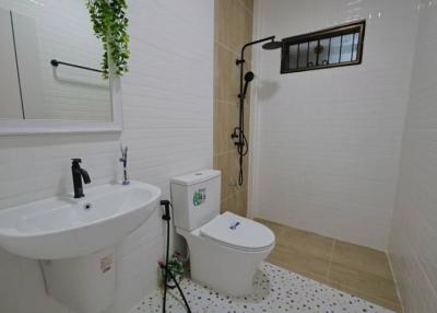 Modern bathroom with white fixtures and tile