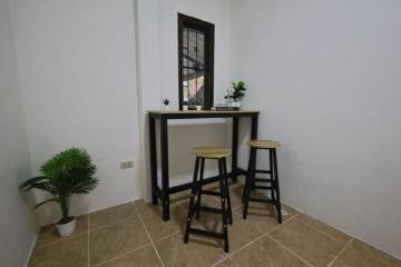 Cozy nook with high stools and decorative plants