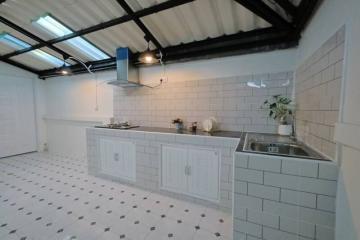 Modern kitchen with white cabinetry and stainless steel fixtures