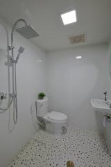 Modern bathroom with white tiles and fixtures