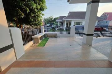 Spacious front porch with tiled flooring and garden view