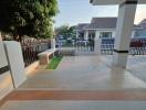 Spacious front porch with tiled flooring and garden view