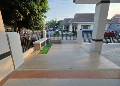 Spacious front porch with tiled flooring and garden view