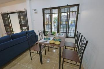 Contemporary dining area with large windows and modern furniture