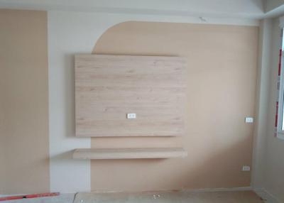 Unfurnished living room with a wooden accent wall feature