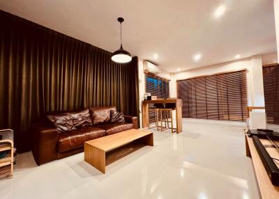 Spacious and modern living room with stylish furnishings and lighting