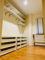 Spacious walk-in closet with built-in shelves and ample storage space