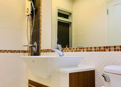 Modern bathroom interior with wall-mounted sink, toilet, and shower