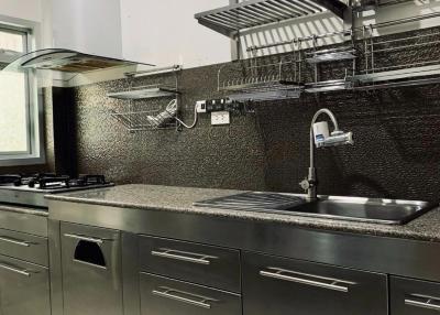 Modern kitchen with stainless steel fittings and appliances