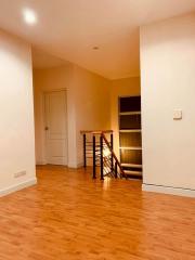 Spacious living area with wooden floors and ample natural light