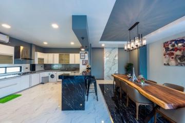 Modern kitchen with marble countertop and wooden breakfast bar