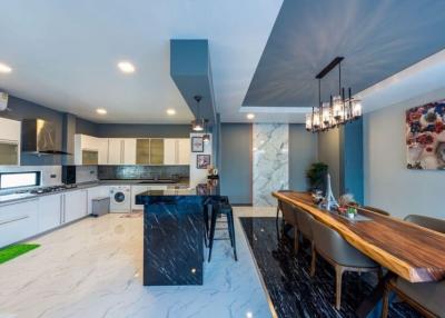Modern kitchen with marble countertop and wooden breakfast bar