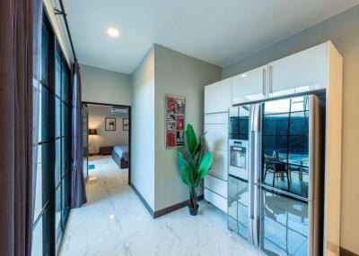 Modern kitchen with stainless steel appliances and a view to the bedroom