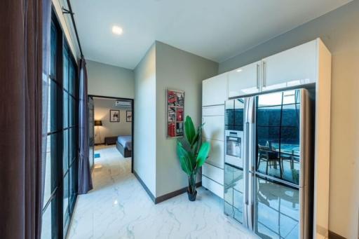 Modern kitchen with stainless steel appliances and a view to the bedroom