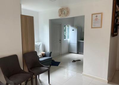 Corridor leading to the living area with adjacent kitchen entrance