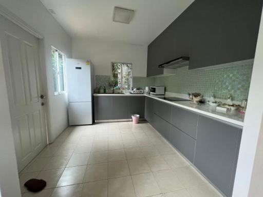 Modern kitchen with stainless steel appliances and tiled flooring