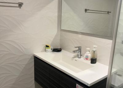 Modern bathroom interior with a vanity cabinet and large mirror