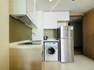 Modern kitchen with stainless steel appliances and white cabinetry