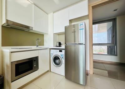 Modern kitchen with stainless steel appliances and a view from the window