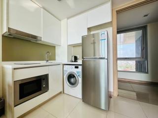 Modern kitchen with stainless steel appliances and a view from the window