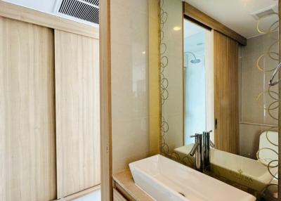 Modern bathroom with vanity and patterned glass door