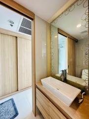 Modern bathroom with vanity and patterned glass door