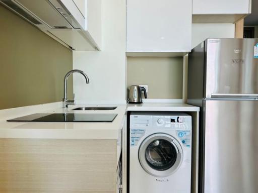 Modern kitchen with built-in appliances and laundry machine