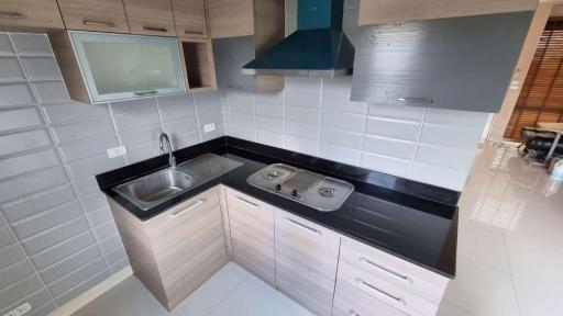 Modern kitchen with stainless steel appliances and white tiles