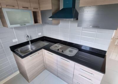 Modern kitchen with stainless steel appliances and white tiles