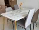 Modern dining area with marble table and comfortable chairs