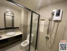 Modern bathroom with glass shower enclosure, wall-mounted toilet, and vanity