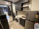 Modern kitchen with stainless steel appliances and washer