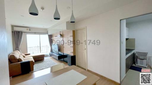 Bright and well-furnished living room with an open layout connecting to the kitchen