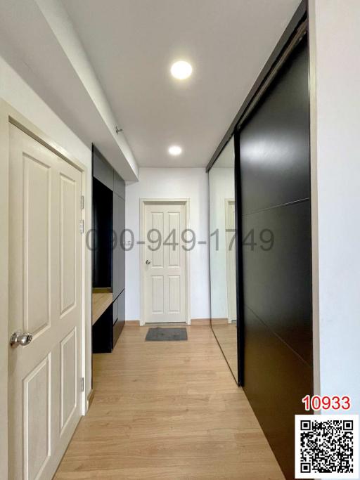 Modern hallway interior with wooden flooring and white doors