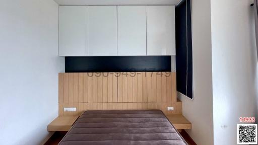 Modern bedroom interior with queen-sized bed and built-in cabinets