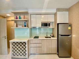 Modern kitchen with wooden cabinets and stainless steel appliances