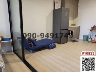 Compact studio apartment interior with kitchen area and sleeping mattress