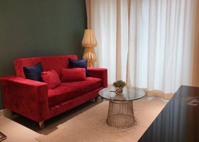 Elegantly furnished living room with red sofa and modern coffee table