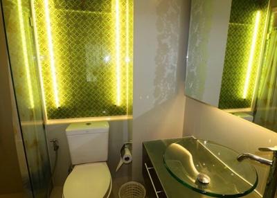 Contemporary bathroom with green accent lighting and modern fixtures