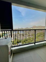 Spacious balcony with cityscape and mountain view plus a washing machine