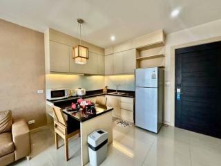 Modern kitchen with stainless steel appliances and pendant lighting