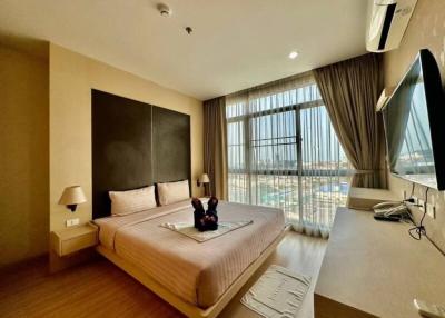 Modern bedroom with a large bed and panoramic window